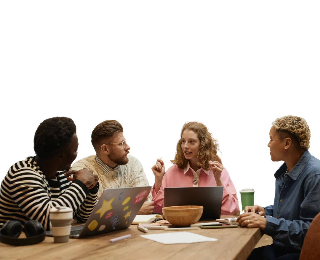 Un grupo de personas sentadas alrededor de una mesa con laptops.